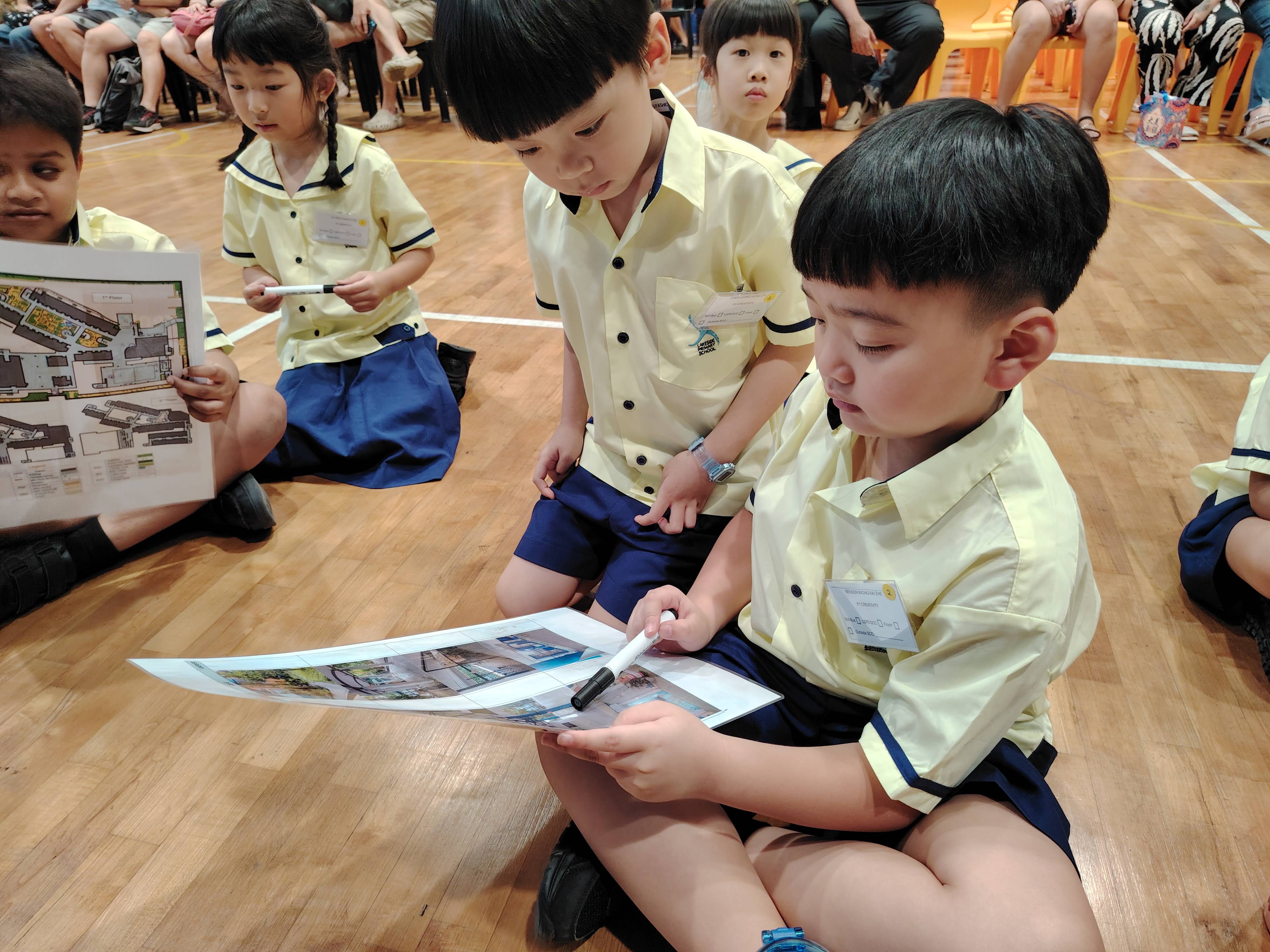 Two P1 students work together to look for key landmarks in school